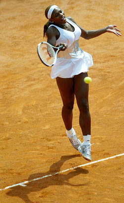 Serena Williams of the USA hits a forehand return