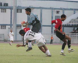 JCT Phagwara�s Harvinder Singh and Mahindra United goalkeeper Naseem Akhtar in a tussle for supremacy in the eighth National Football League match at Ludhiana�s Guru Nanak Stadium 