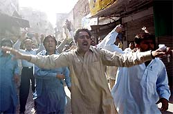 Supporters of Pakistan Muslim League chant anti-government slogans on Shahbaz Sharif's return from exile in Lahore on Tuesday