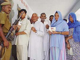 Voters await their turn during repolling at the Khadri polling booth in Yamunanagar on Wednesday.
