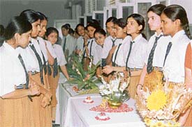 Students watch flower arrangements at Atam Public School in Ludhiana