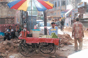 Hawkers and potholes take up most of the space on Ansari Road
