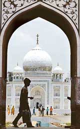 A boy selling icecreams looks for buyers at the construction site of a life-size wooden replica of the Taj Mahal in Mumbai on Wednesday. The replica is being built using wood and thermacol at an estimated cost of $ 550,000 as a tourist attraction. 