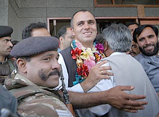 President of the National Conference Omar Abdullah gets a hug from a party worker outside a counting hall in Srinagar on Thursday. 