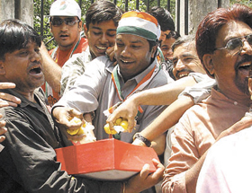 Congress workers celebrating their party victory at the residence of Sonia Gandhi in the Capital on Thursday.