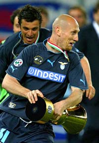 Lazio's Jaap Stam and Massimo Oddo run with the trophy after defeating Juventus in the Italian Cup final second leg match at the Delle Alpi Stadium in Turin