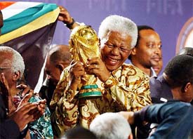 Former South African President Nelson Mandela lifts the World Cup trophy in Zurich 