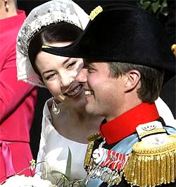 Denmark's Crown Princess Mary smiles at her husband, Crown Prince Frederik, as they leave the Copenhagen Cathedral in a horse-drawn carriage 