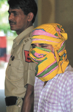 Dr Ravi Kumar of Safdarjung Hospital, being produced in the court in the Capital on Sunday. 