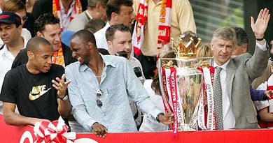 Arsenal's famous French trio striker Thierry Henry, skipper Patrick Viera and coach Arsene Wenger celebrate Arsenal's victory in the English Premier League 