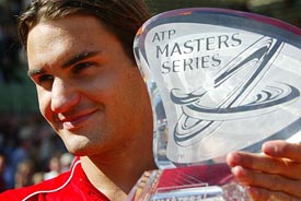 Roger Federer of Switzerland smiles with the trophy after winning the Hamburg Masters tennis tournament