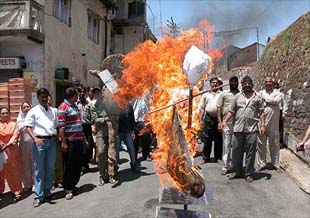 Residentals of the Jutogh Cantonment area burn an effigy of Col Y.S. Shrinath, near Shimla on Monday.