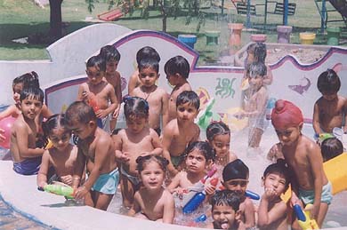 Kids of Chandamama Play School, Green Enclave, enjoy water games on the school campus