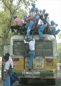 Schoolchildren of Patti village, Amritsar, get off a bus.