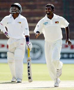 Muralitharn smiles after taking the wicket of Brendon Taylor in Bulawayo, Zimbabwe