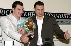 Vitali and Wladimir Klitschko of the Ukraine give a thumbs up holding the WBC heavyweight belt during their news conference in Moscow