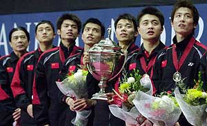 China's badminton team members stand in line with the Thomas Cup during the ceremony after they won the final in Istora Senayan Stadium 