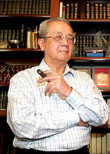 French lawyer Jacques Verges, 80, who is part of the legal team asked to act for captured Iraqi President Saddam Hussein, smokes a cigar after a news conference at his office in Paris 
