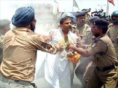 Policemen try to stop local Shiv Sena leader Pramod Chugh from immolating himself in Bhopal on Tuesday. Chugh attempted self-immolation to protest against Ms Sonia Gandhi becoming the Prime Minister. 