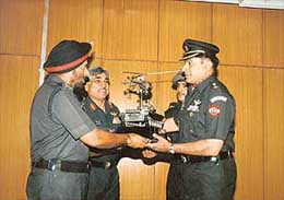 Lieut-Col S.P. Savant (right) of the 661 Army Aviation Squadron receives the Flight Safety Trophy from the GOC-in-C, Western Command, Lieut-Gen J.J. Singh, at Chandi Mandir on Wednesday.