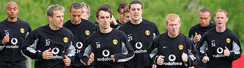 The Manchester United team led by Gary Neville runs during training at Carrington, near Manchester, on Wednesday