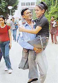 Physically challenged Poonam from Pathankot, who appeared for the AIEEE, being carried out of the examination hall by her father Jagdish in Chandigarh on Thursday.