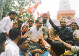 Congress workers distributing sweets after the elevation of Dr Manmohan Singh as PM