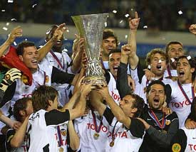 Valencia players celebrate with the UEFA Cup after beating Olympique Marseille in the final 
