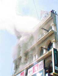 Smoke billows out of the Navrang Tower building