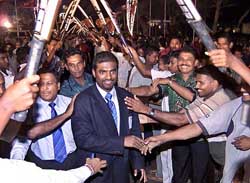 Cricket fans cheer as Sri Lanka spinner Muttiah Muralitharan arrives at the Sri Lanka Cricket headquarters in Colombo