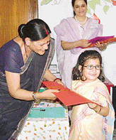 A girl dressed as Sonia Gandhi gets a prize at a fancy dress competition in Chandigarh on Saturday.