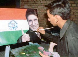 Ashok Kumar Goswami makes a portrait of Amitabh Bachchan in his house in Shimlapuri