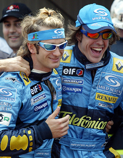 Italian Formula One driver Jarno Trulli being congratulated by Spanish teammate Fernando Alonso after Trulli clocked the best time in the qualifying session 