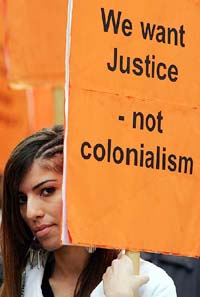 A woman takes part in a demonstration outside the US Embassy in London on Saturday