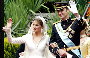 Spanish Crown Prince Felipe and his newly wed Princess Letizia wave at supporters outside Basilica of Atocha after placing the bridal bouquet