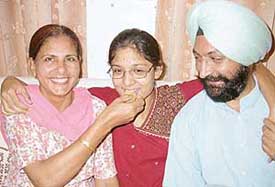 Amrita Kaur, who topped in the CBSE Class XII examinations in Mohali, with her parents