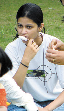 A girl enjoys an ice candy at Boat Club in the Capital on Sunday. 