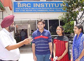 A teacher explains a point to some of the toppers at a teaching centre in Sector 19, Chandigarh, on Monday.