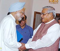 Former Prime Minister Atal Bihari Vajpayee greets his successor, Dr Manmohan Singh