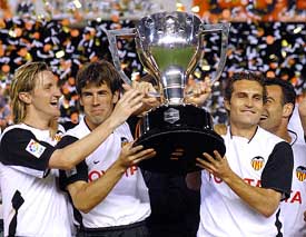 Valencia's Miguel Angel Ferrer "Mista", David Albelda and Ruben Baraja hold the Spanish league trophy after winning the Spanish League Championship