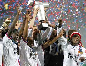 The Lyon football team celebrates their win against Lille in the French Champions Cup final in Lyon 