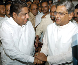 Senior Karnataka minister Dharam Singh being congratulated by caretaker Chief Minister S.M. Krishna