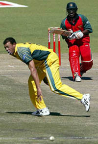 Zimbabwe batsman Tatenda Taibu calls for a run after driving past Australian bowler Andrew Symond