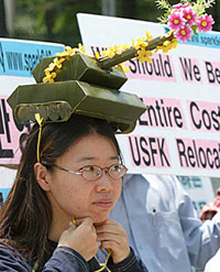 A South Korean protester with a miniature of military tank