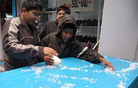 Tourists play with hailstones in Shimla