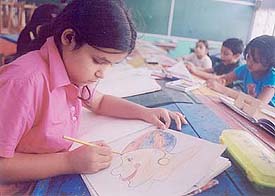 Students absorbed in painting during a workshop held in Sacred Heart Convent School during the summer camp