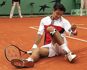 Paradorn Srichaphan of Thailand grimaces after a fall during his second round match against Alex Corretja of Spain