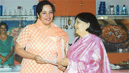 Ms Molly Bajaj receives a prize for the best recipe at a cookery contest.