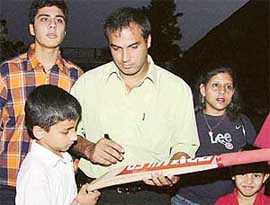 Former Test player Robin Singh gives autographs to children during his visit to St Stephen�s School, Sector 45, Chandigarh, on Friday. 