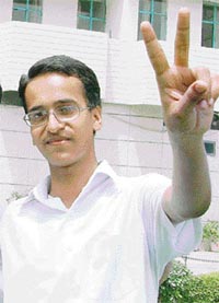 Arun (96%) of Ludhiana flashes the victory sign after the declaration of results on Friday. 
